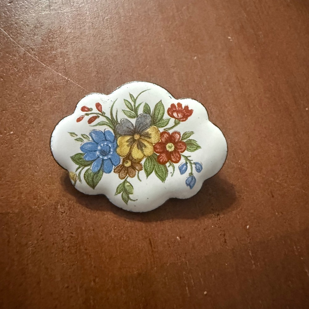 Small metal enamel brooch. Features beautiful flowers on a white background VTG